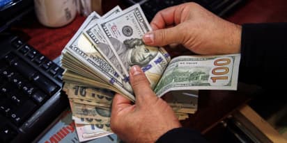 Dollar gains before key inflation data